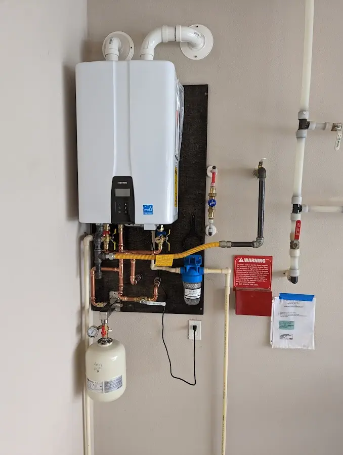 Professional plumber installing copper piping in a Little Falls home